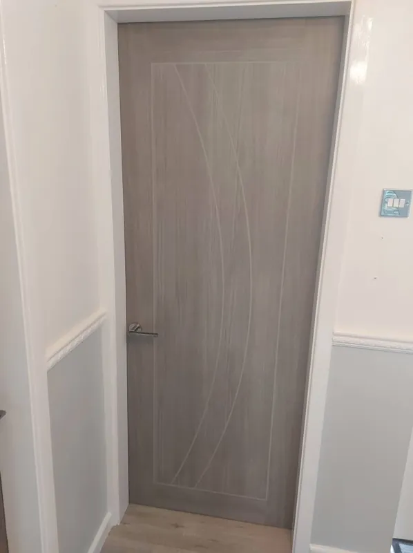 Grey woodgrain door fitted in a white frame